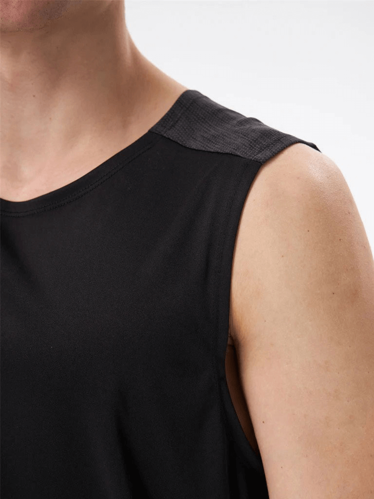 Close-up of black breathable men's tank top with O-neck collar, showcasing fabric texture and double-color design for gym workouts.